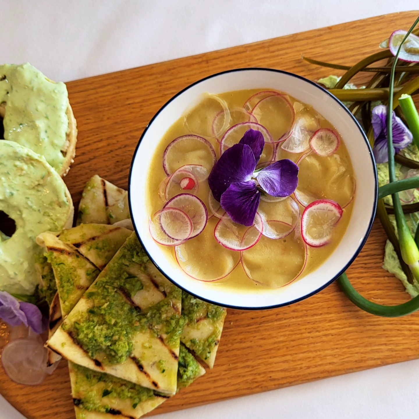 Photo of a roast porchetta with the Hotel's colourful facade in the background
